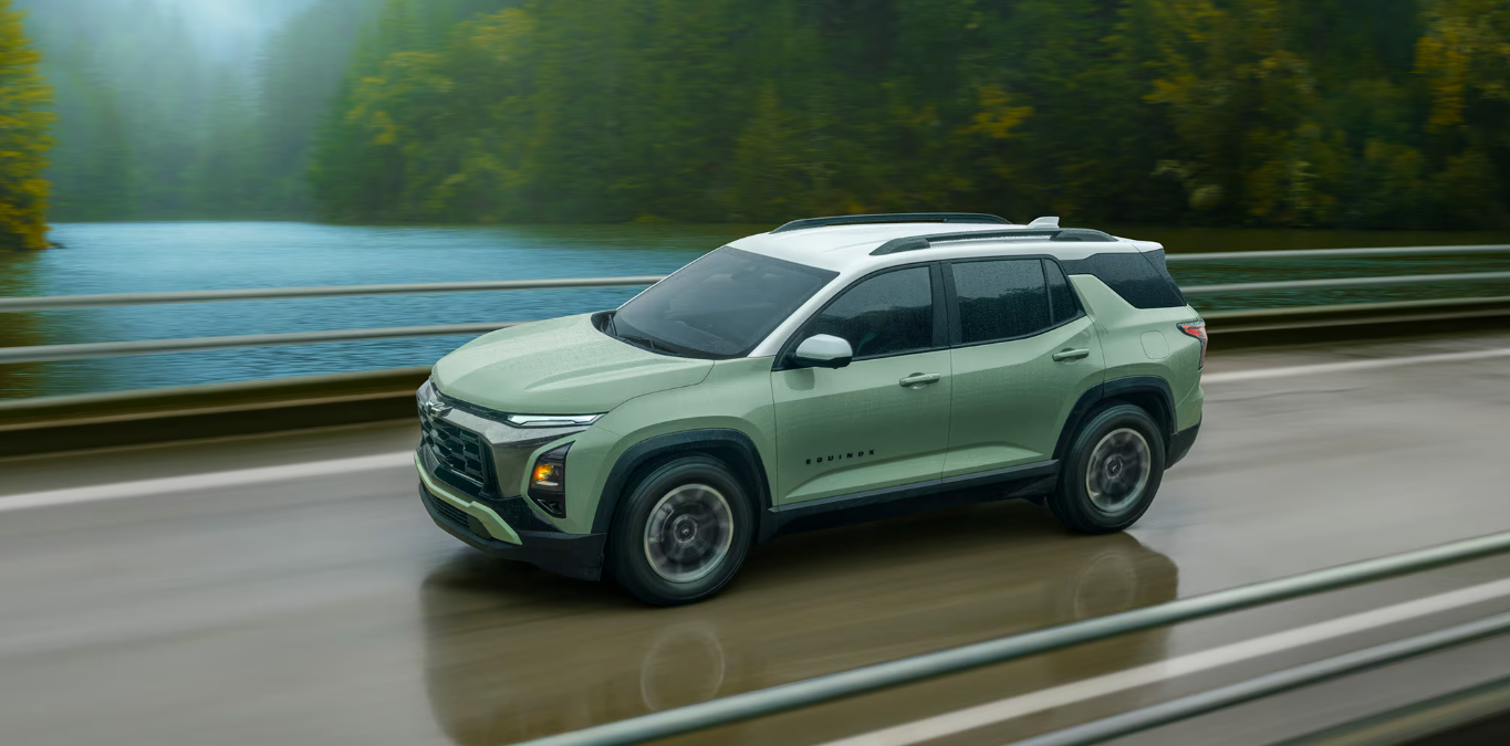 Side profile view of the 2026 Chevrolet Equinox driving over a bridge