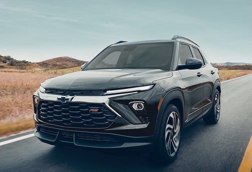 A black 2026 Chevrolet Trailblazer SUV driving down a road