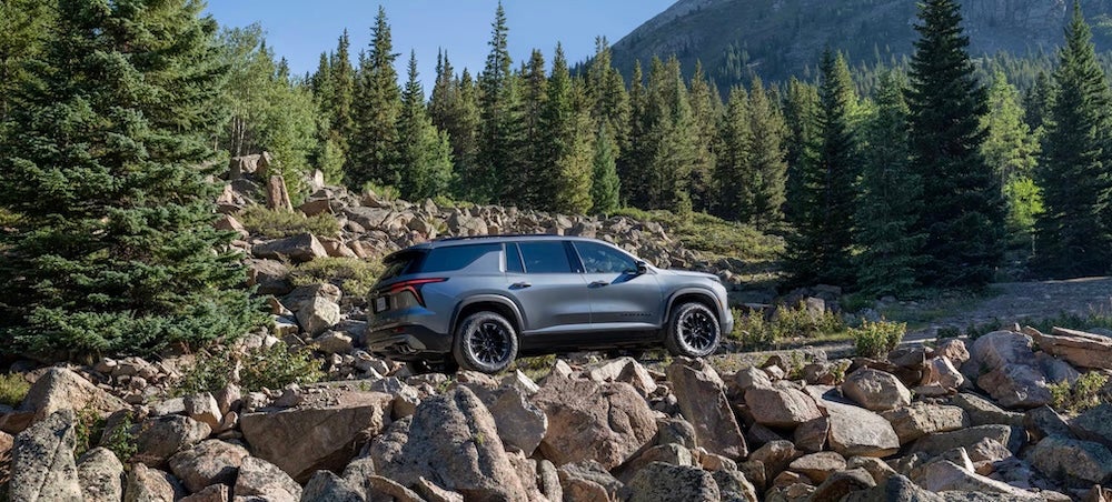 A gray 2026 Chevrolet Traverse SUV on a rocky road