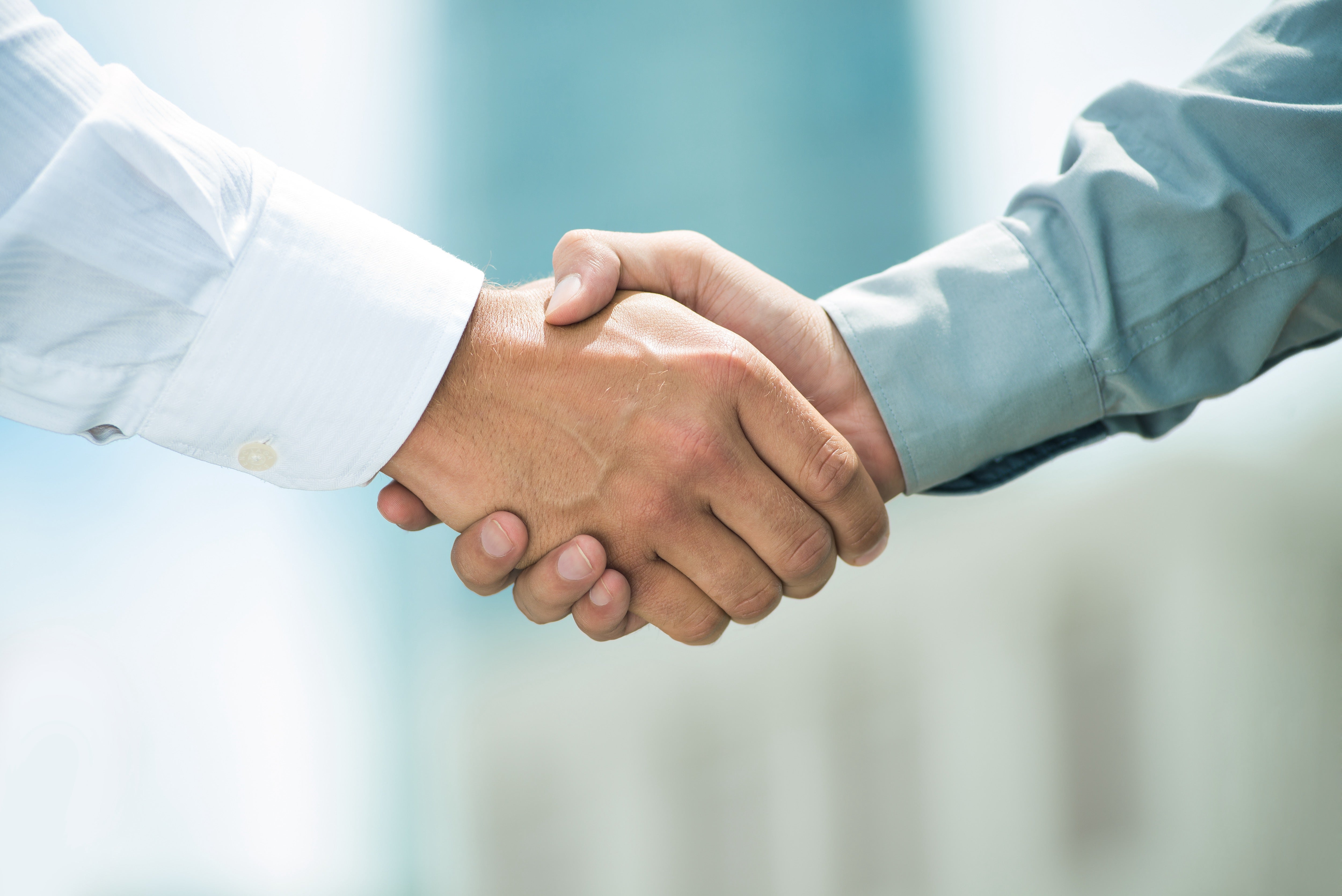 A closeup of two people shaking hands